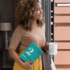 mockup-of-a-woman-looking-out-the-window-holding-a-15-oz-mug-and-a-book-28476